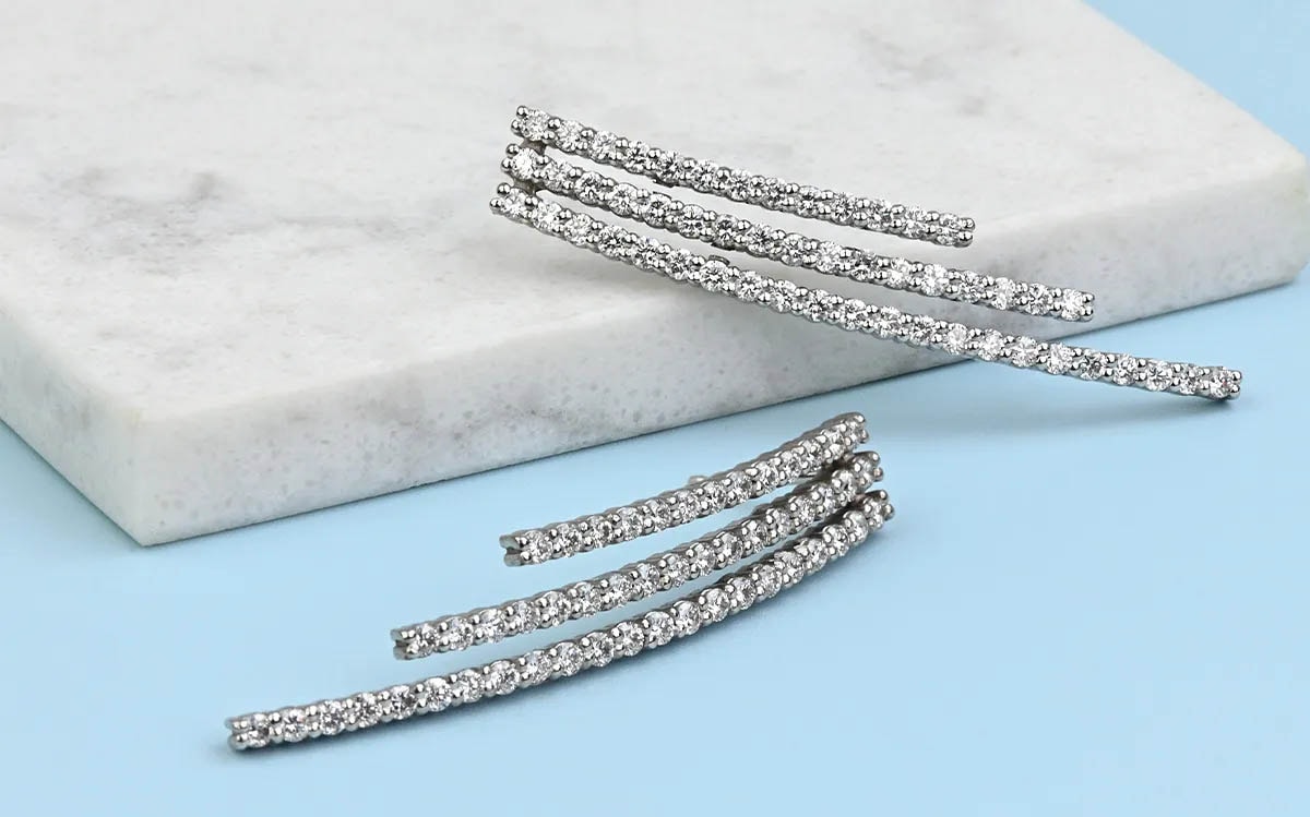 Chandelier earrings on light blue surface