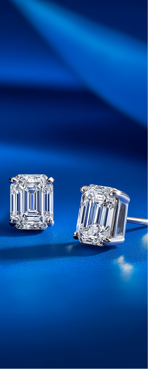 Oval shaped diamond on yellow gold setting on blue surface.