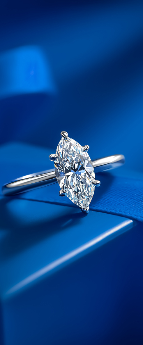 Round diamond engagement ring on blue surface.