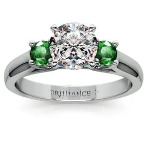 Diamond Engagement Ring With Emerald Side Stones In Platinum