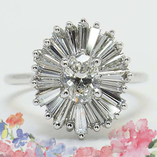 Art Deco style ring with baguette-cut diamonds in a halo setting, showcasing geometric patterns.